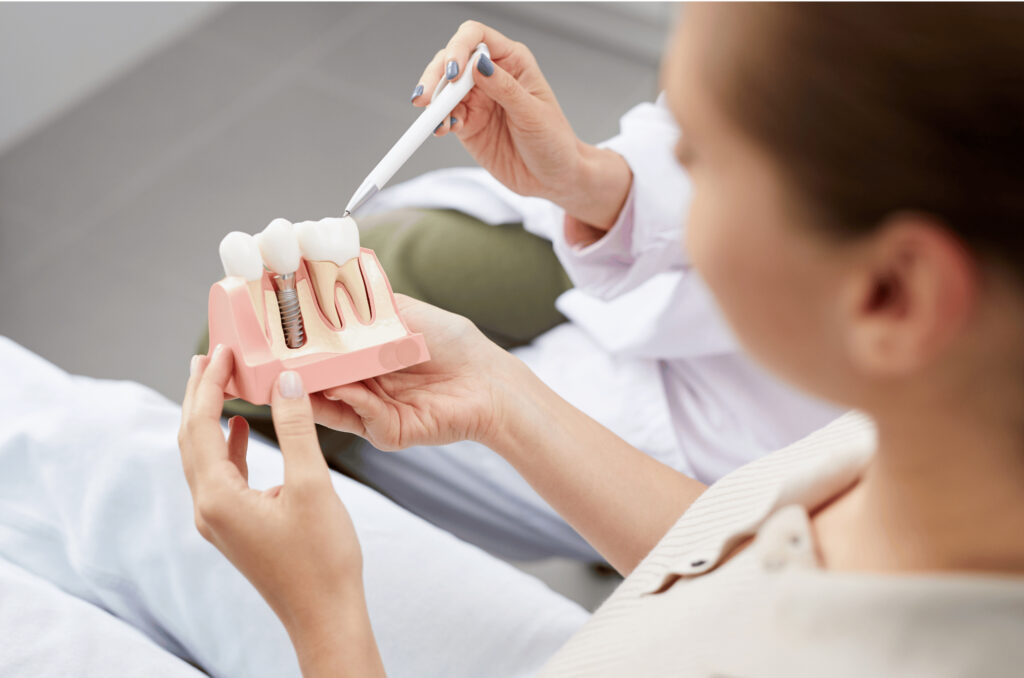 dentist showing the anatomy of a dental implant